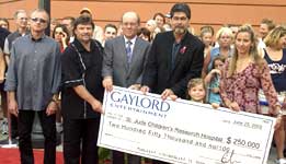 Country music stars present a check to St. Jude