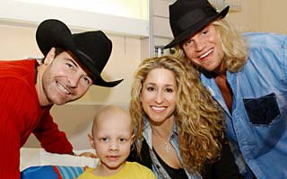 Country band Trick Pony visits with a St. Jude patient.
