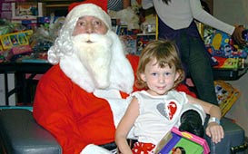 Joe Farris as Santa with a St. Jude patient