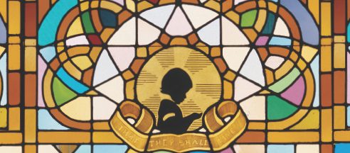 stained glass window with light shining through to represent a donation in memory of a loved one