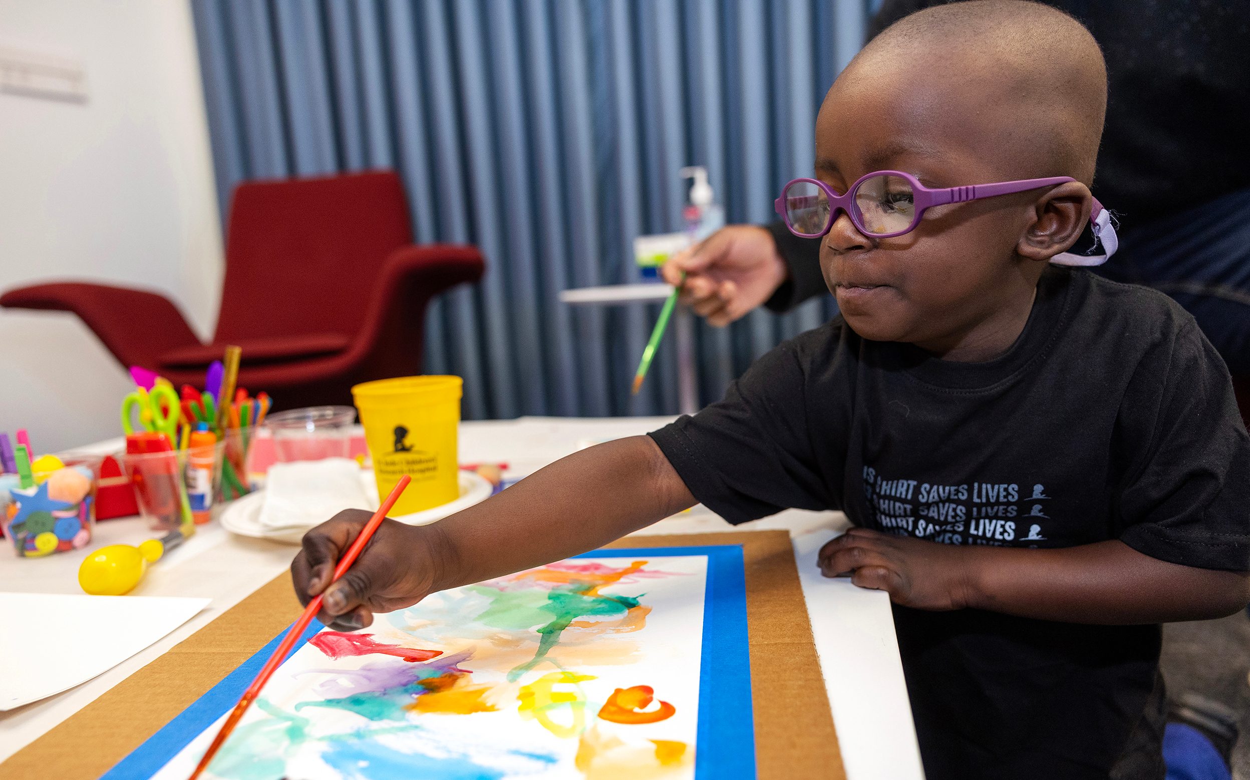 St. Jude patient Hayden paints a picture.
