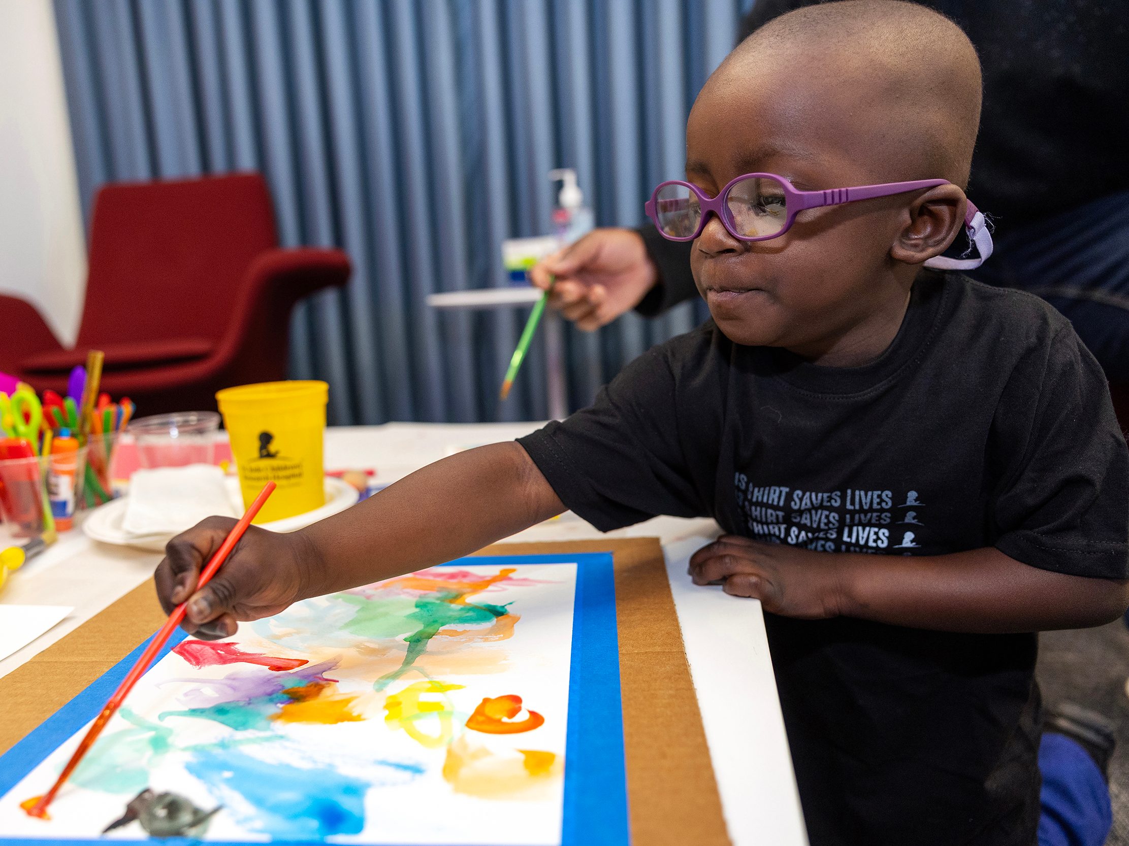 St. Jude patient Hayden paints a picture.