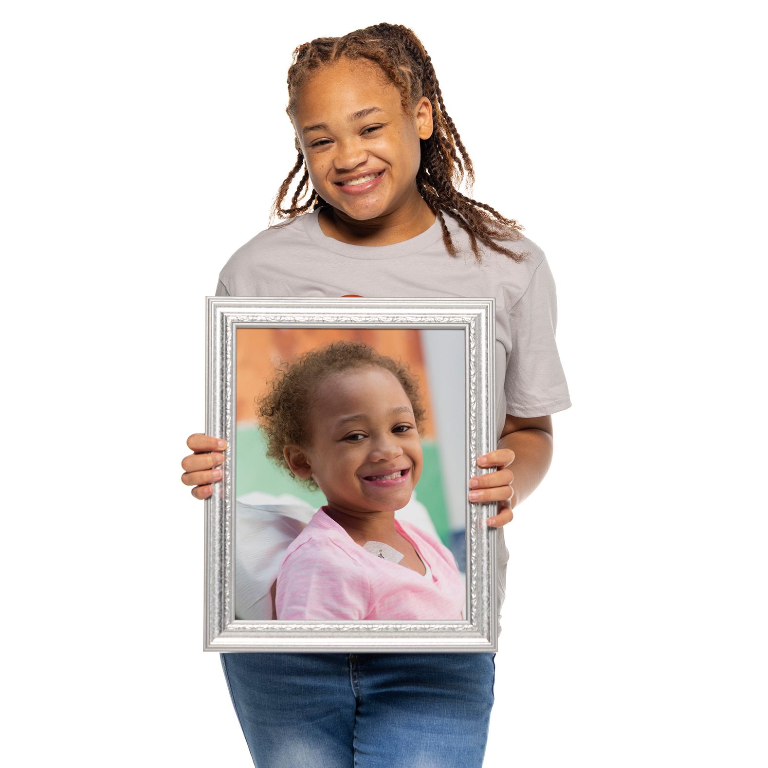 St. Jude survivor Marleigh holds a framed photo of herself from when she was undergoing treatment at St. Jude.