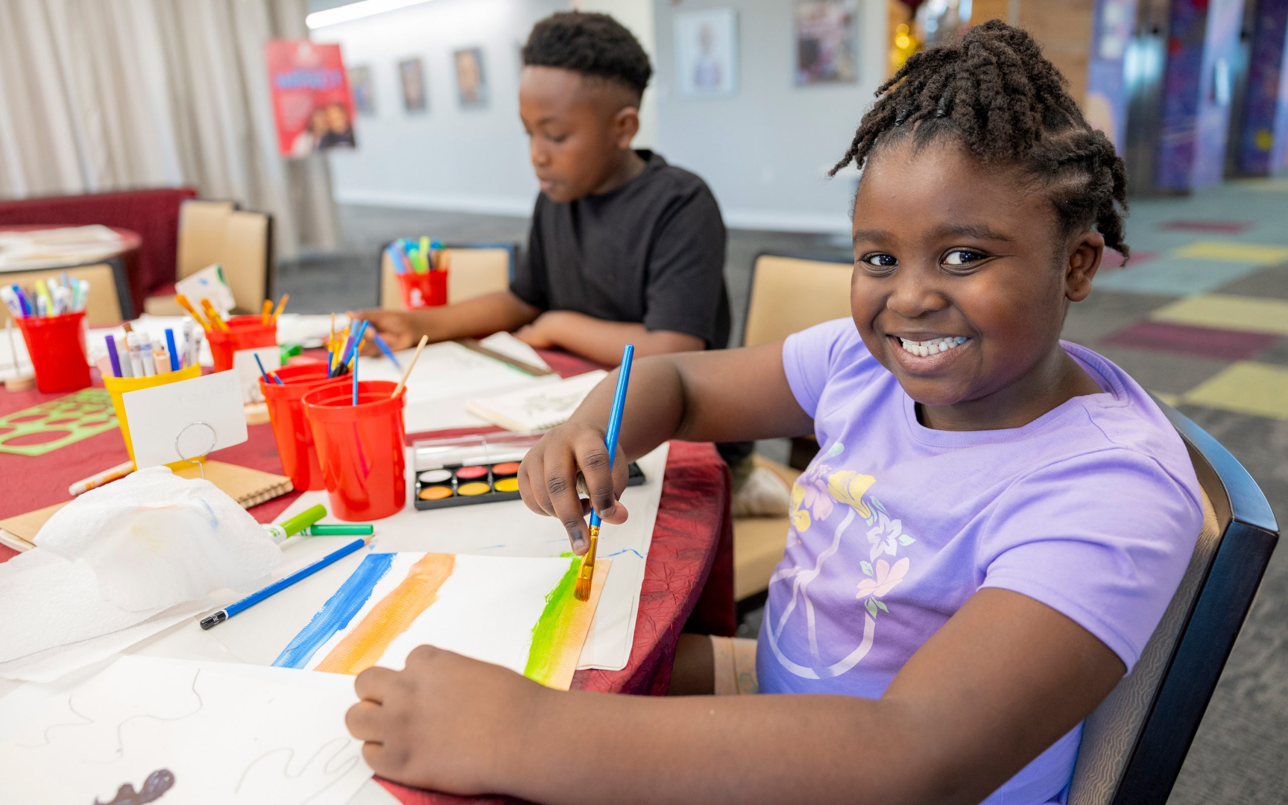 St. Jude patient Bailey painting at an art party.