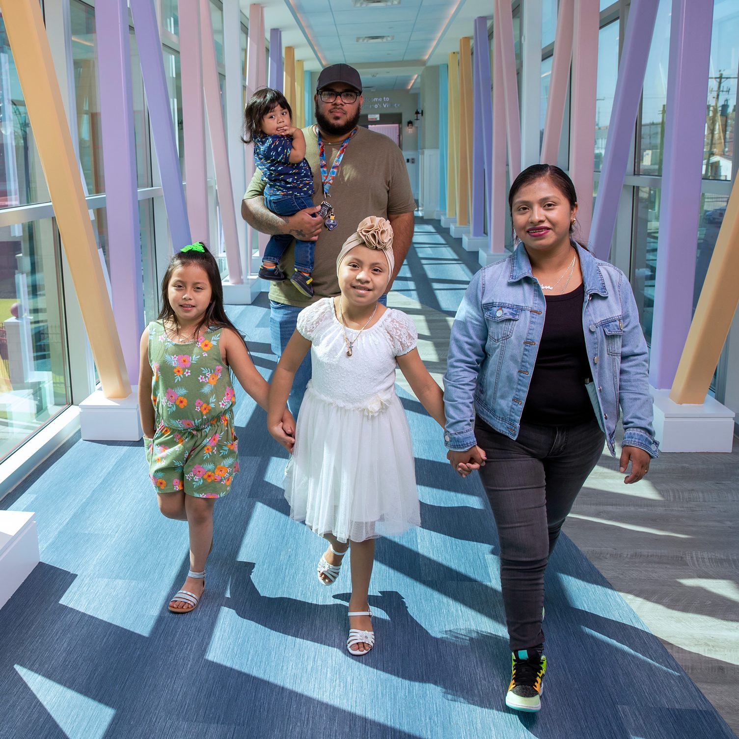 St. Jude patient Liliana and family walk down the halls of St. Jude