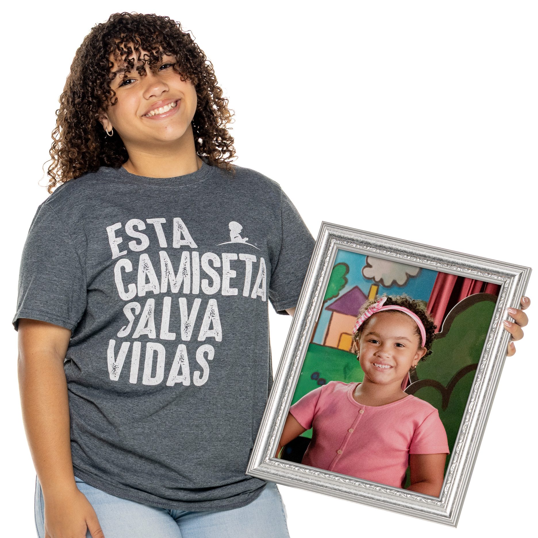 St. Jude patient Mayela holding a photo of herself as a child.