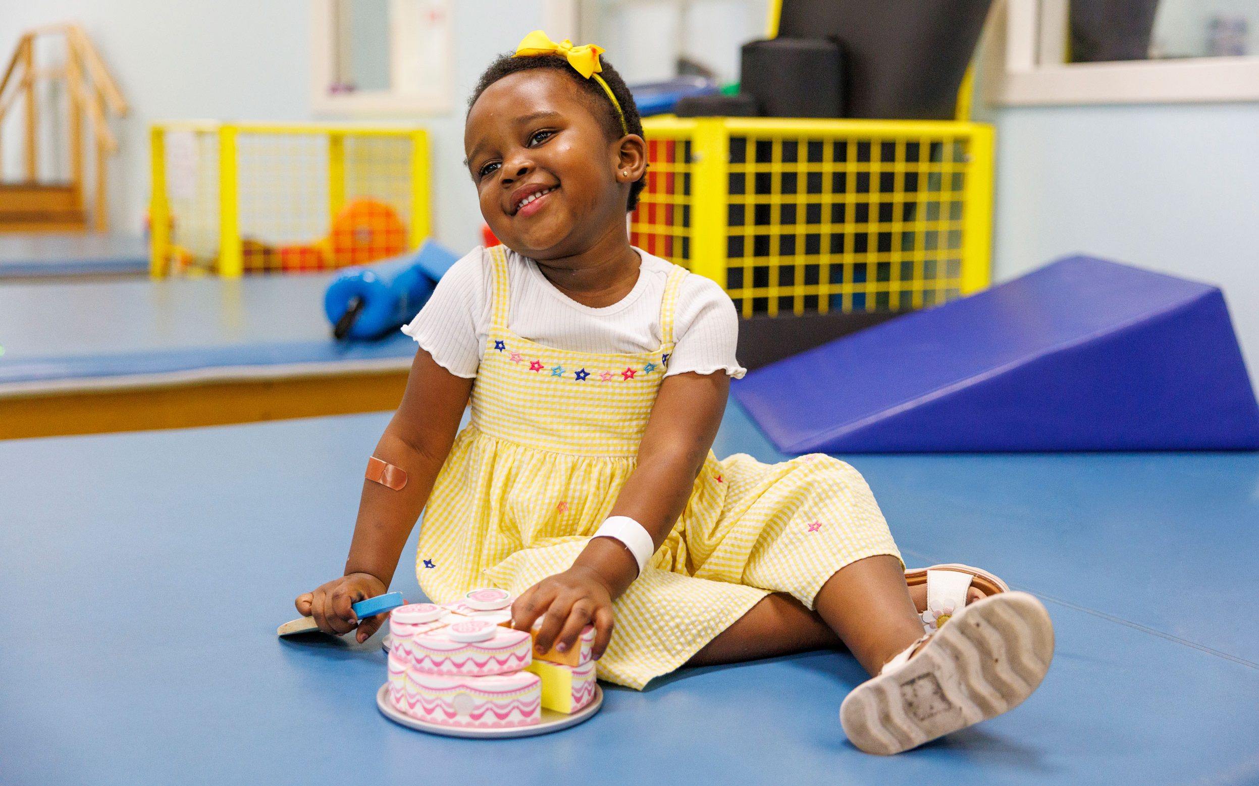 St. Jude patient Reagan smiles for the camera during her physical therapy.