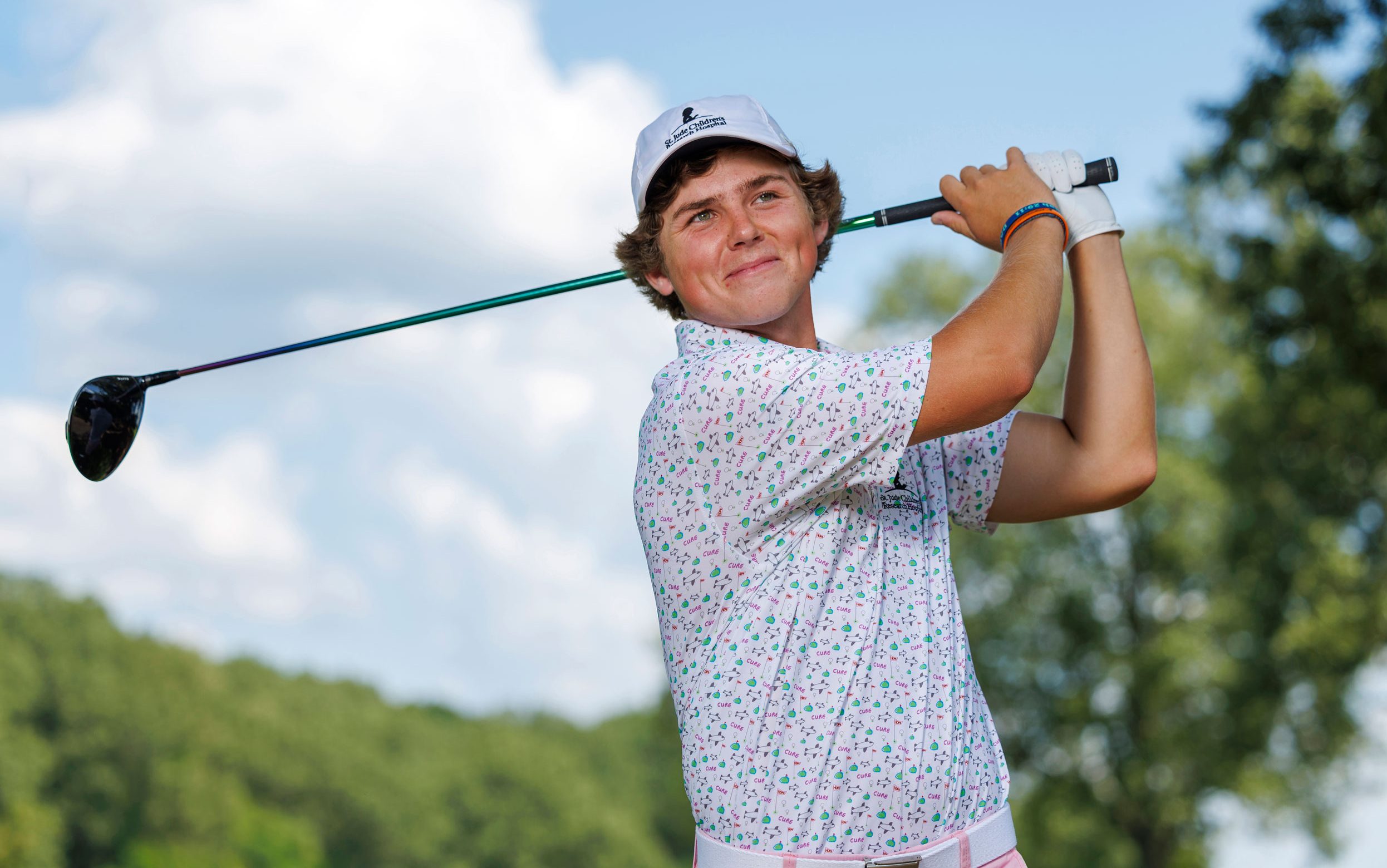 St. Jude patient Dakota in the Partner in Hope golf polo