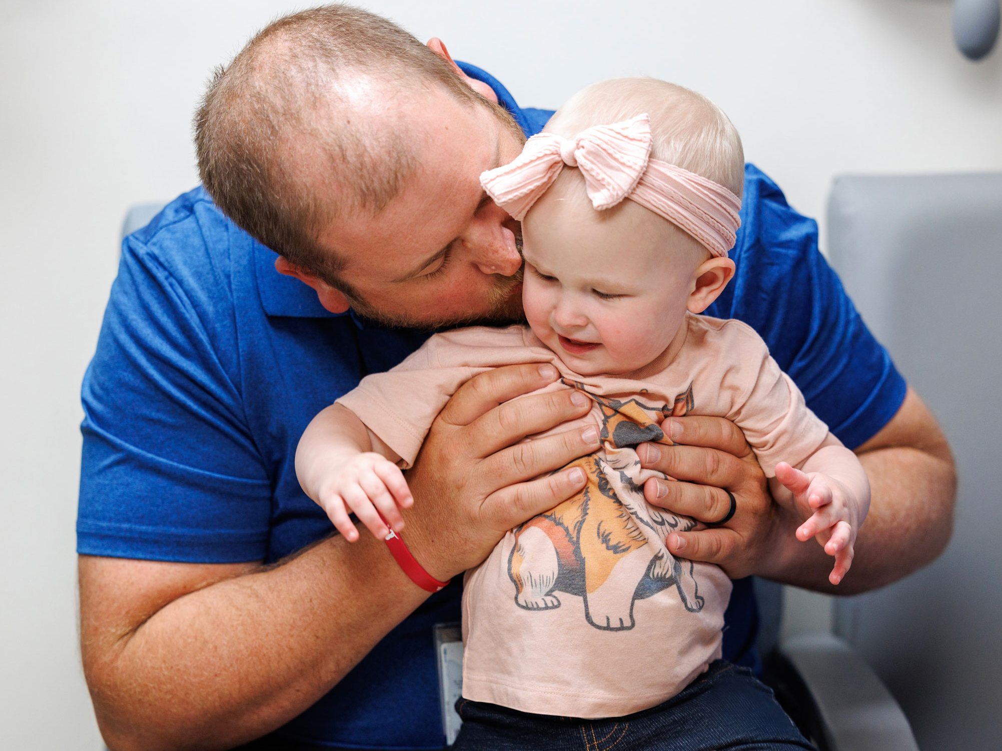 St. Jude patient Rylee being held by her dad, Miles