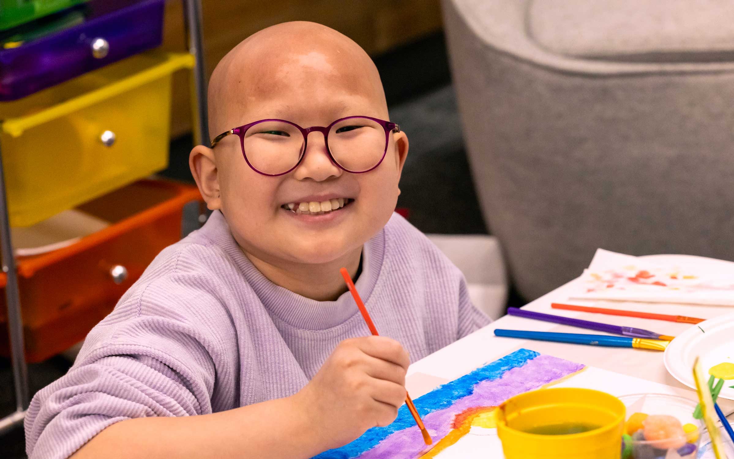 St. Jude patient Misheel painting a picture