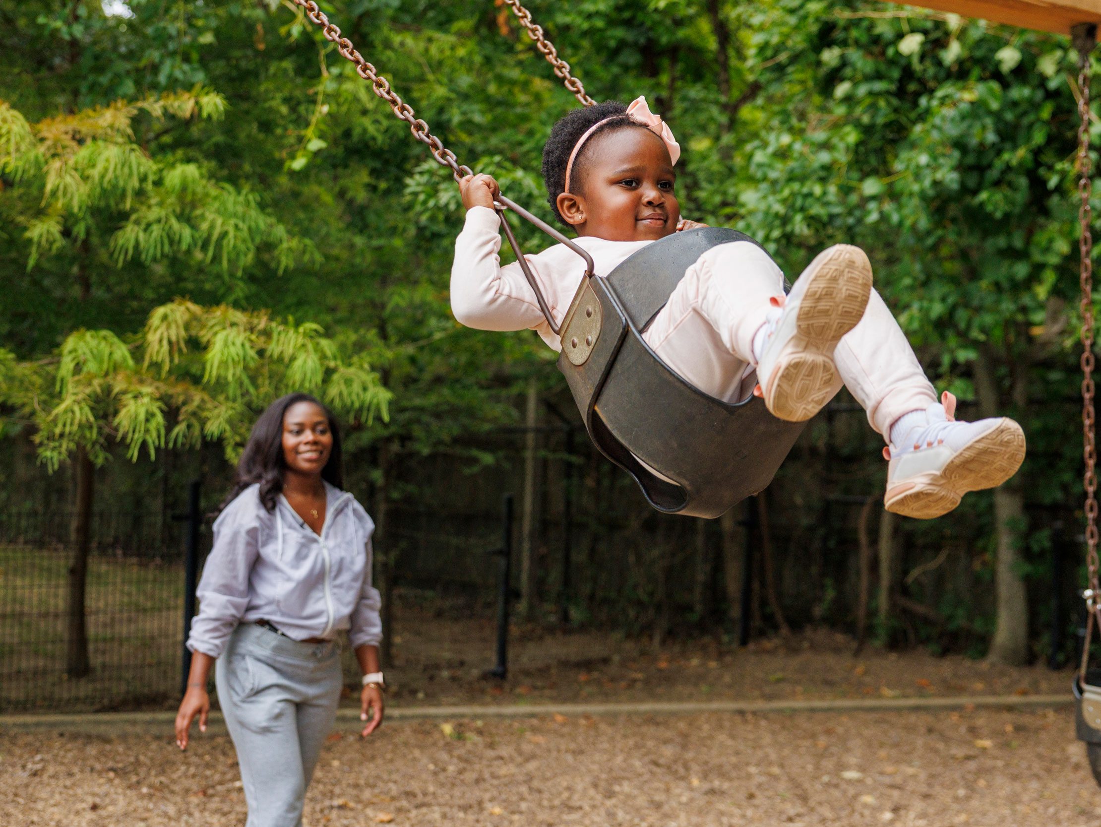 St. Jude patient Reagan is pushed on a swing by her mother.