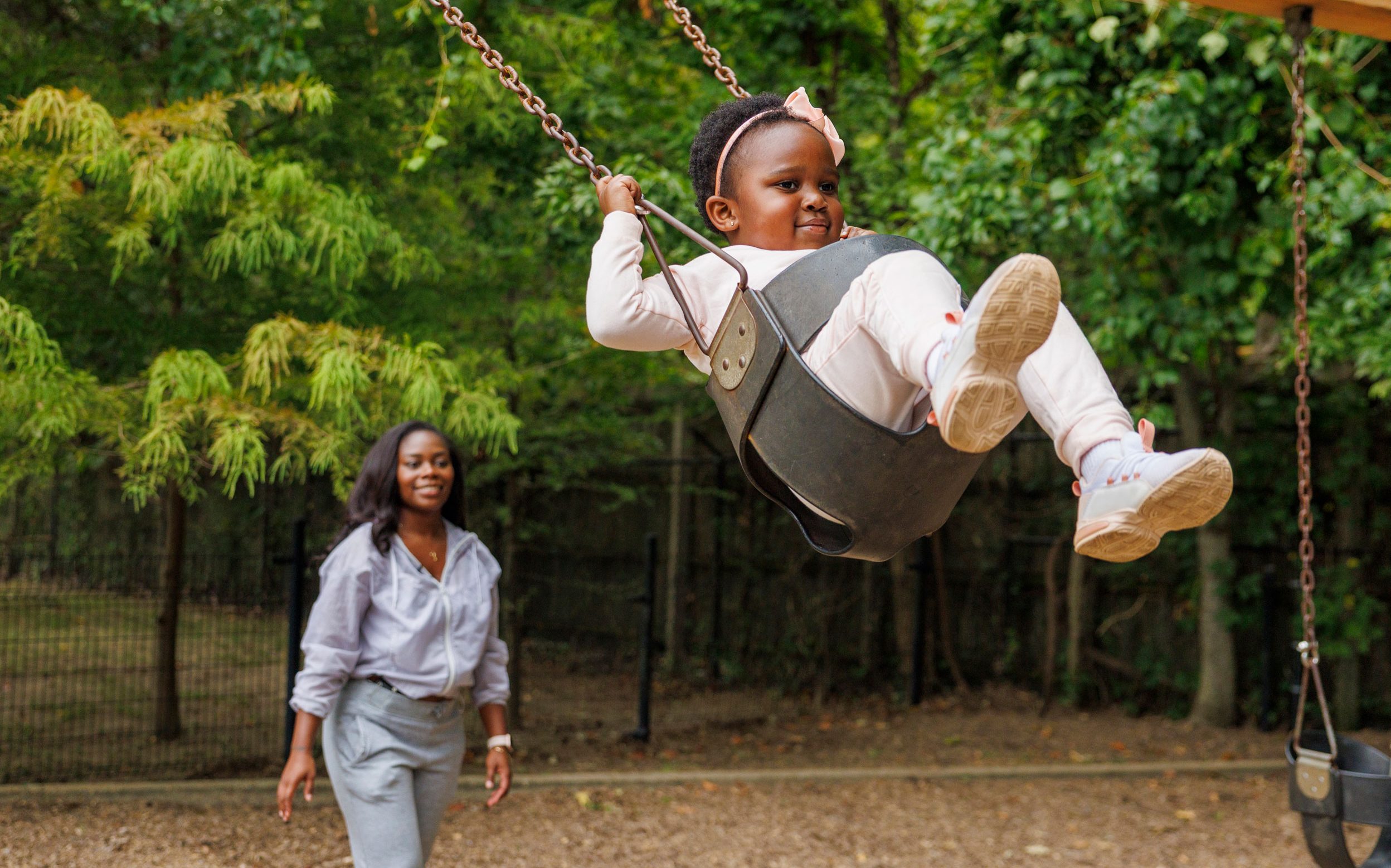 St. Jude patient Reagan is pushed on a swing by her mother.