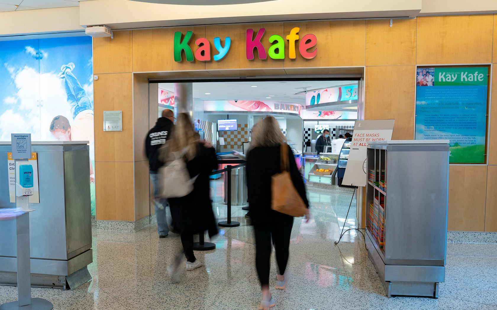 People waking into the Kay Kafe
