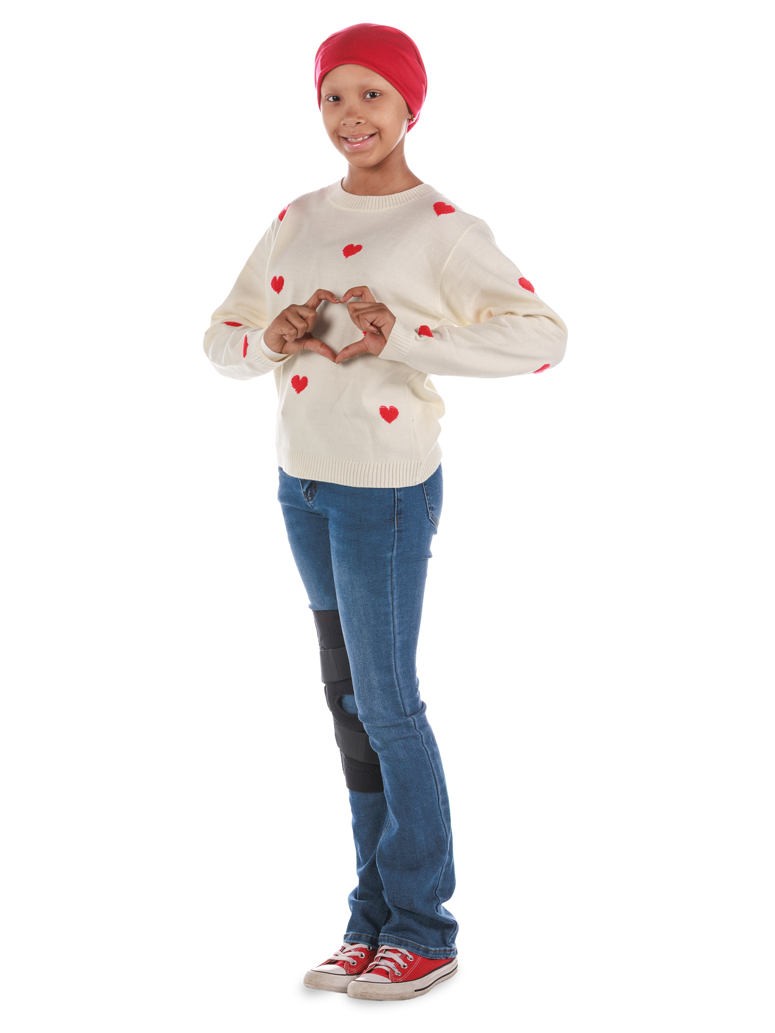 St. Jude patient Laylah makes a heart symbol with her hands.