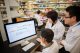 The individuals pictured are exploring interactive genomic visualizations by using ProteinPaint within St. Jude Cloud.