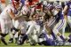 Arkansas Razorback #3 getting tackled with the ball.