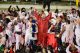 Arkansas Razorbacks holding up their hands in celebration.
