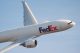 A FedEx airplane flies over the AutoZone Liberty Bowl stadium