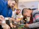A Best Buy employee shows a little boy new gadgets.