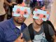 St. Jude patient Juan and a Best Buy employee wear their robot masks.