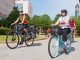 Mary Jo Belak, Clinical Trials Administration (foreground), wheels around the campus.