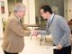 Gerry Zambetti shakes hands with Peng Xu.