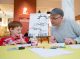 Lincoln Peirce, creator of the comic strip “Big Nate,” draws with St. Jude patient Andrew