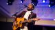 Travis Greene sings and plays the guitar.
