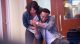 Erica Campbell and Travis Greene hugging after singing together.