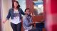 Erica Campbell and Travis Greene singing together while he plays the piano.