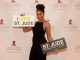 A woman posing on the step and repeat with I love St. Jude signs