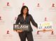 A woman posing on the step and repeat with I love St. Jude signs
