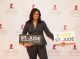 A woman posing on the step and repeat with I love St. Jude signs