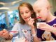 St. Jude patient Juliana and her sister take the taste test.