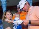 Professional golfer signing an autograph for a patient
