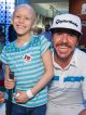 Patient posing with professional golfer