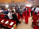 The graduating students enter the room and walk down the isle.