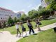 Graduate school students walk across campus.