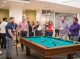 Graduate school students play pool.