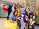 A patient dressed as a mermaid posing with the Disney princesses group