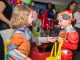 Two kids exchange candy.