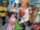 A mad scientist hands out candy to a small girl.