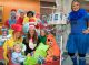 Dr. Seuss poses with patients trick-or-treating in a wagon.