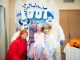 St. Jude patient Emma dressed as a unicorn and poses with characters from Smallfoot.