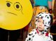 St. Jude patient Anderson dressed as a dalmation and looks at an emoji.