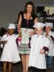 St. Jude teacher Michaela Shurden leads graduates Khamoni and Aidan.