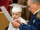 Graduate and grandfather reading the program.