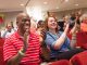 Family members and friends clapping in the audience.