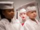 Graduates sitting on stage.