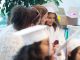 A girl smiles in her cap and gown.